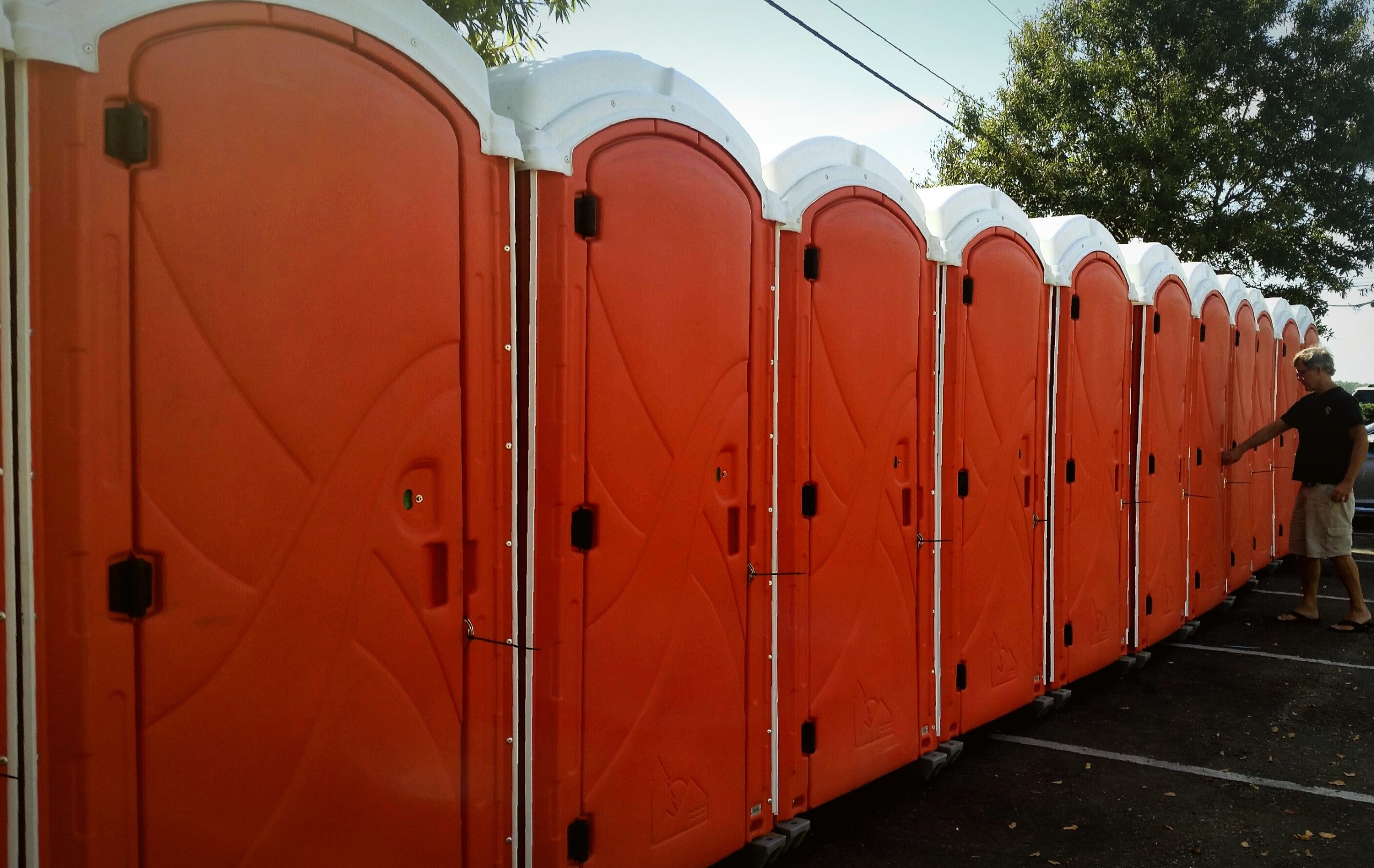 orange-outdoor-bathrooms-for-use-at-outdoor-event-2025-02-15-16-41-02-utc